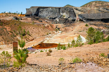 Rio Tinto river and iron mines. Red tinted river by copper, iron on the ground. Water used in life...