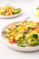 This healthy salad combines boiled millet, chickpeas, fresh vegetables, and avocado, all drizzled with olive oil for a nutritious and flavorful vegetarian meal