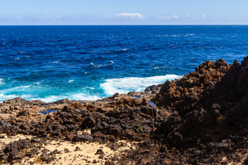 Rocky, volcanic Atlantic ocean coast. Charco de Palo region. Lanzarote, Canary Islands, Spain