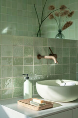 detailed photograph of a light green bathroom with white sink and zellige tiles, bathroom, green
