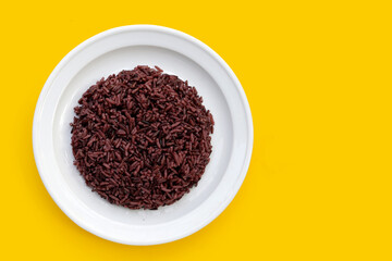 Cooked black berry rice in white plate