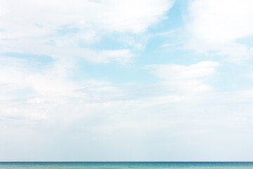 The mostly cloudy sky gives way to a few patches of light blue as a lone gull flies over Lake Michigan in early May along the shoreline of Harrington Beach State Park, Belgium, Wisconsin.