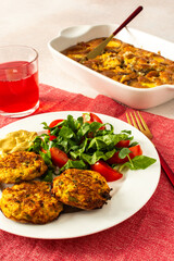 Savor a balanced and appetizing breakfast of zucchini pancakes with fresh lettuce and tomatoes, accompanied by cherry compote and a delightful peach pie for a satisfying morning meal