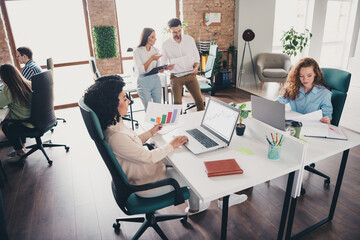 Photo of teamwork young people coworking working together employees modern industrial open space...