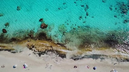 Breathtaking, bird's-eye view shot, taken from a drone of an exotic and colorful beach at Crete, Greece. An exotic sunny island and travel destination for summer vacations.
