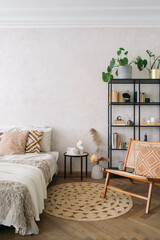 Bedroom interior with jute rug, comfort bed and wooden chair