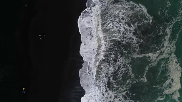 Aerial top view of wave of Black Sand Beach Reynisfjara in Iceland.