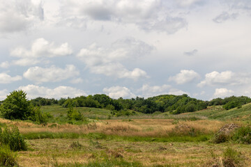 Landscape of a valley with hills and sky in the background