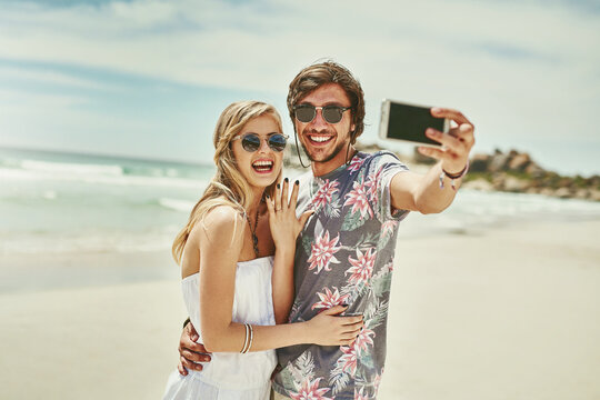 Couple, selfie and smile for engagement at beach on holiday, vacation and profile picture update. Excited people, video call or live streaming on social media for proposal celebration or love in Bali