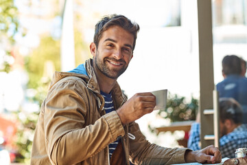 Happy man, drinking tea and portrait at cafe in outdoor, holiday and peace at travel destination. Male person, relax and espresso for calm beverage, restaurant and smile on vacation at coffee shop