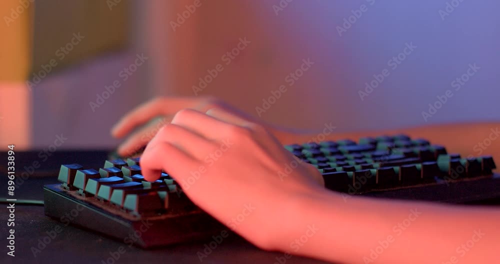 Poster close-up shot hands typing backlit gaming keyboard colorful lighting in setup computer.