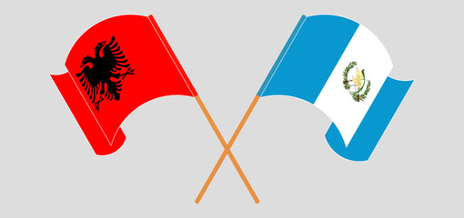 Obraz premium Crossed and waving flags of Albania and Republic of Guatemala