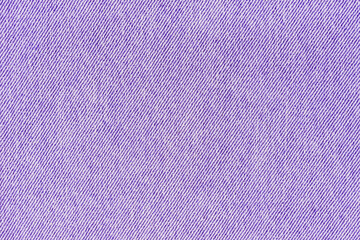 Closeup, macro of purple jeans denim fabric texture background, cloth with diagonal weawing