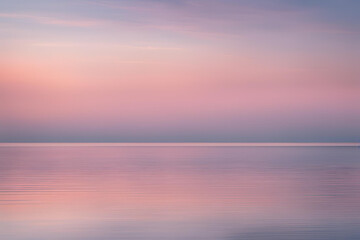 Fototapeta premium Tranquil seascape with pastel twilight colors and serene water reflections.