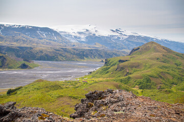 Rivers meandering through the Thorsmork valley in South Iceland during Summer amidst panoramic backdrop of mountains and glaciers