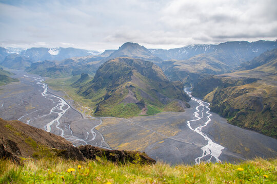 Rivers meandering through the Thorsmork valley in South Iceland during Summer amidst panoramic backdrop of mountains and glaciers