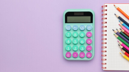 Colorful Calculator and Notepad with Pencils on Purple Background