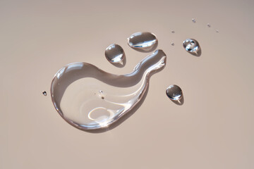 A drop of micellar water on a beige background.