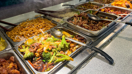 various Asian dishes, including stir-fried noodles, beef and broccoli, and mixed vegetables