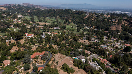 Fototapeta premium Afternoon aerial view of the sprawling neighborhood houses and hills of La Habra Heights, California, USA.
