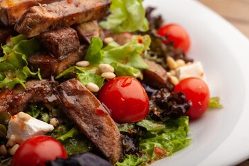 Chicken meat with tomato and salad on plate. Fastfood concept.