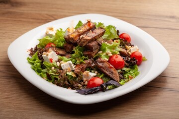 Chicken meat with tomato and salad on plate. Fastfood concept.