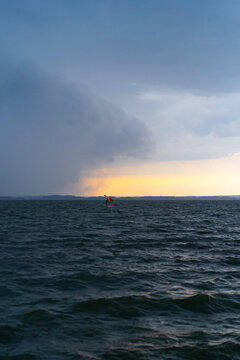 Wingfoil rider riding in the lake.