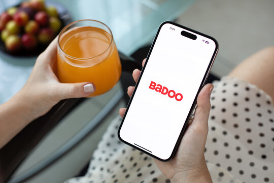 Woman hands holding Apple iPhone 15 Pro Max with Badoo