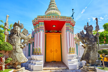 Two giants at Wat Pho temple complex in Bangkok, Thailand