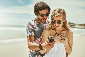 Excitement, phone and surprise with couple on beach together for holiday, travel or vacation. Love,...