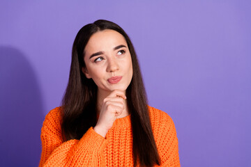 Photo of cute pretty minded girl wear trendy orange clothes look empty space isolated on purple...