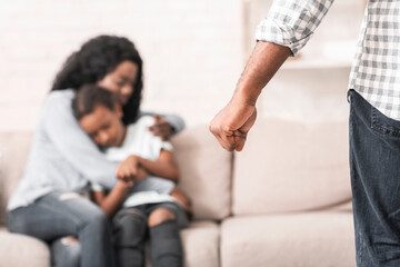 Domestic violence. Mother and daughter suffering from home abusement, mom protecting kid from father's fist.