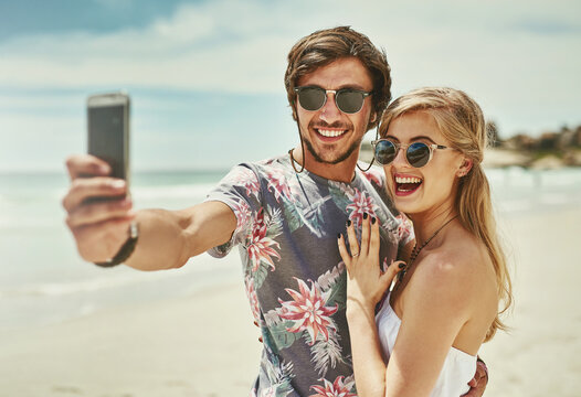 Couple, selfie and happy for engagement at beach on holiday, vacation and profile picture update. Excited people, video call or live streaming on social media for proposal celebration or love in Bali
