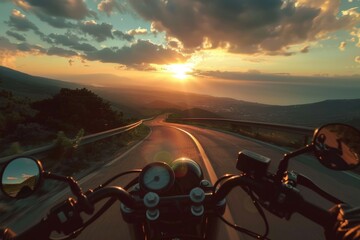 A motorcyclist riding their bike on a winding road as the sun sets in the background