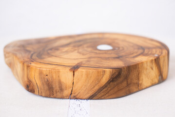 Wooden kitchen board. Epoxy resin tray on the table. Wooden slice of walnut. Circle