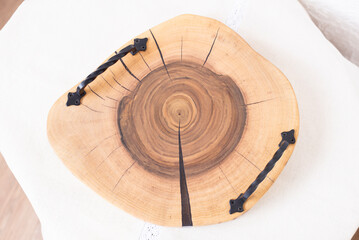 Wooden kitchen board. Epoxy resin tray on the table. Wooden slice of walnut. Circle