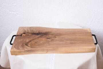Wooden kitchen board. Working board made of walnut wood with epoxy resin. Food tray