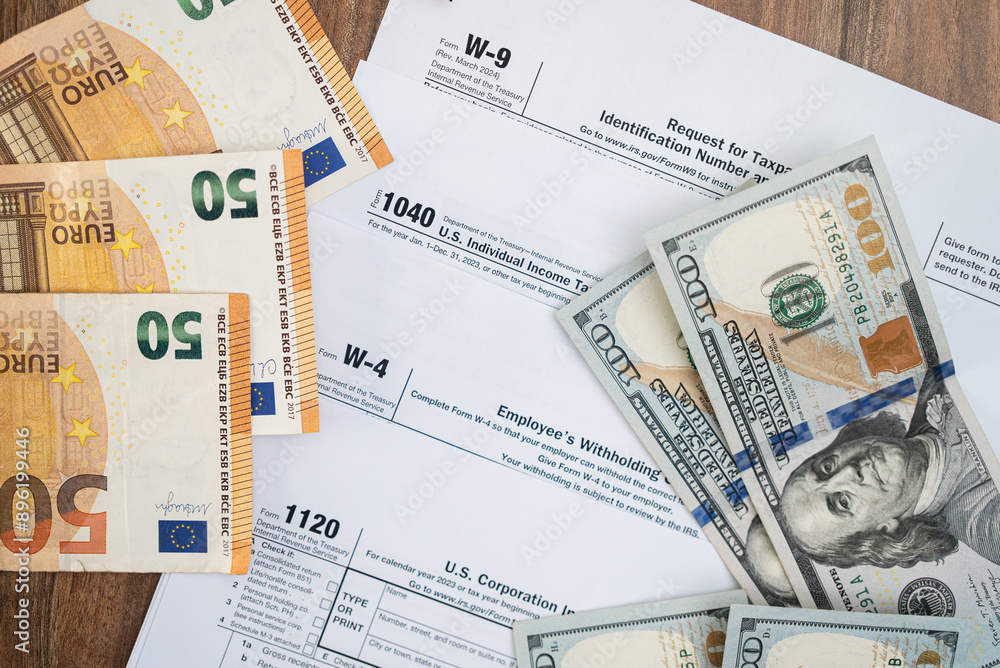 Poster banknotes of dollar and euro currency placed on different tax forms necessary for taxpayers to repor