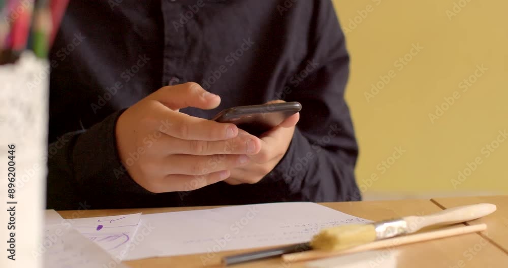 Poster the scene shows a closeup of hands using a smartphone on a desk in an office setting with papers and