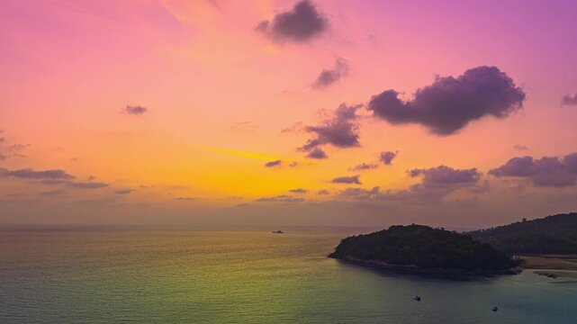 aerial hyperlapse the sun above Kala island at Layan beach Phuket.
colorful sky of sunset at horizon.Phuket beach sea Amazing beach, 
Beautiful beach Phuket Thailand, Nature and travel concept.