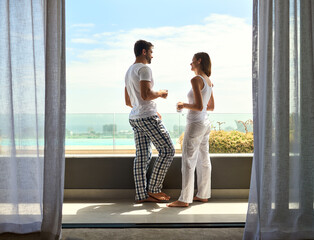 Balcony, coffee and morning with couple in hotel room together for holiday, travel or vacation....