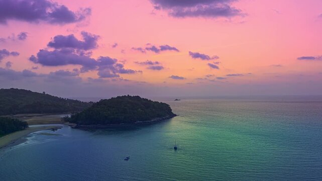 aerial hyperlapse view colorful sky of sunset above Kala island at Layan beach Phuket.
video 4K. Nature video High quality footage. 
Scene of Colorful romantic sky in sunset with cloud in the sky