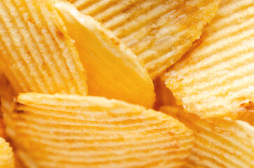 Close up of a bunch of ruffled potato chips. 