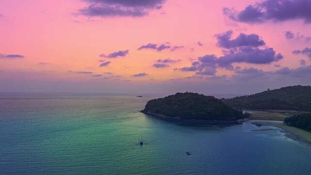 aerial hyperlapse view colorful sky of sunset above Kala island at Layan beach Phuket.
video 4K. Nature video High quality footage. 
Scene of Colorful romantic sky in sunset with cloud in the sky 