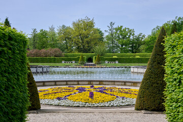 beautiful colorful garden with fountains, flowers, trees and shrubs