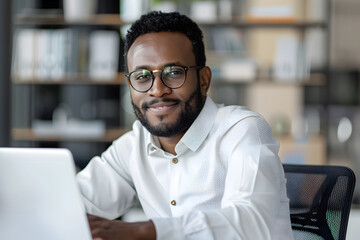 Obraz premium Handsome African American man in his 30s wearing a white shirt in the office, working in the modern office, looking in the camera