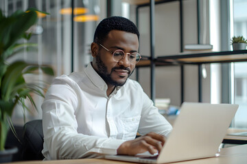 Obraz premium Handsome African American man in his 30s wearing a white shirt in the office, working in the modern office, looking in the camera
