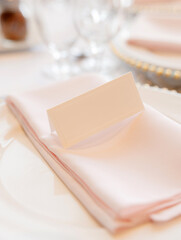 Beautiful plate with a napkin with a blank label for the designer's inscription. Beautiful luxury plate close-up. Blank space for writing text on restaurant label