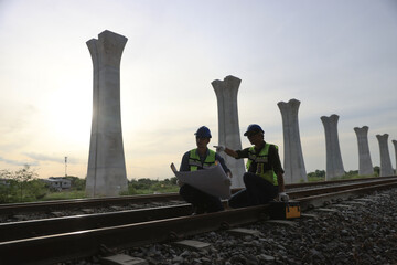 Civil engineers team are  working outside to check on  the build of a high-speed railway.