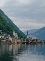 Fototapeta premium Hallstatt village reflecting on tranquil lake during cloudy day